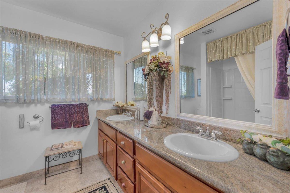 16397 Road 37 Madera, CA 93636 - Photo 23 of 74 a bathroom with a double vanity sink and a mirror