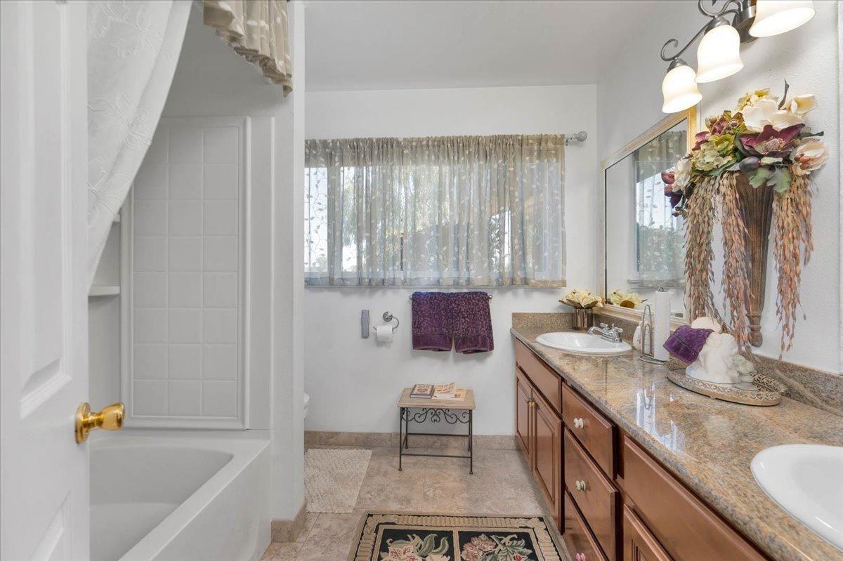 16397 Road 37 Madera, CA 93636 - Photo 24 of 74 a bathroom with a tub sink and mirror