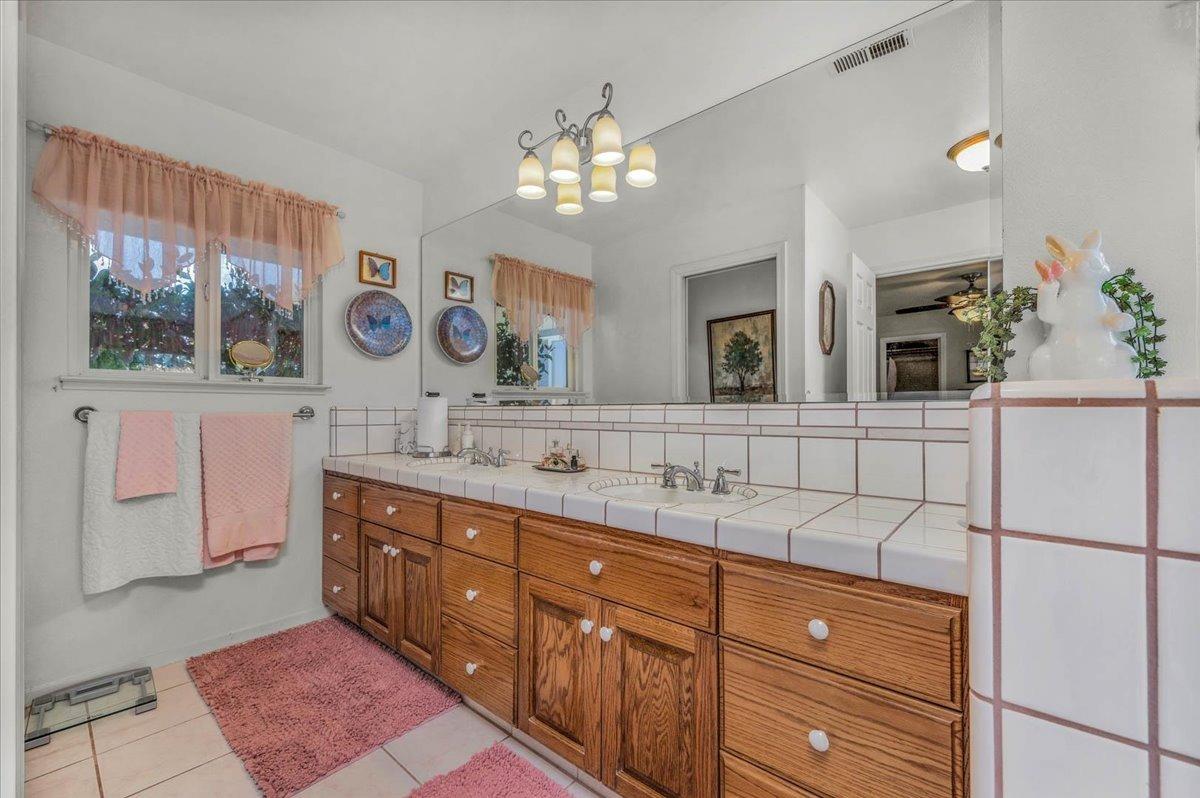 16397 Road 37 Madera, CA 93636 - Photo 28 of 74 a spacious bathroom with a double vanity sink and a mirror