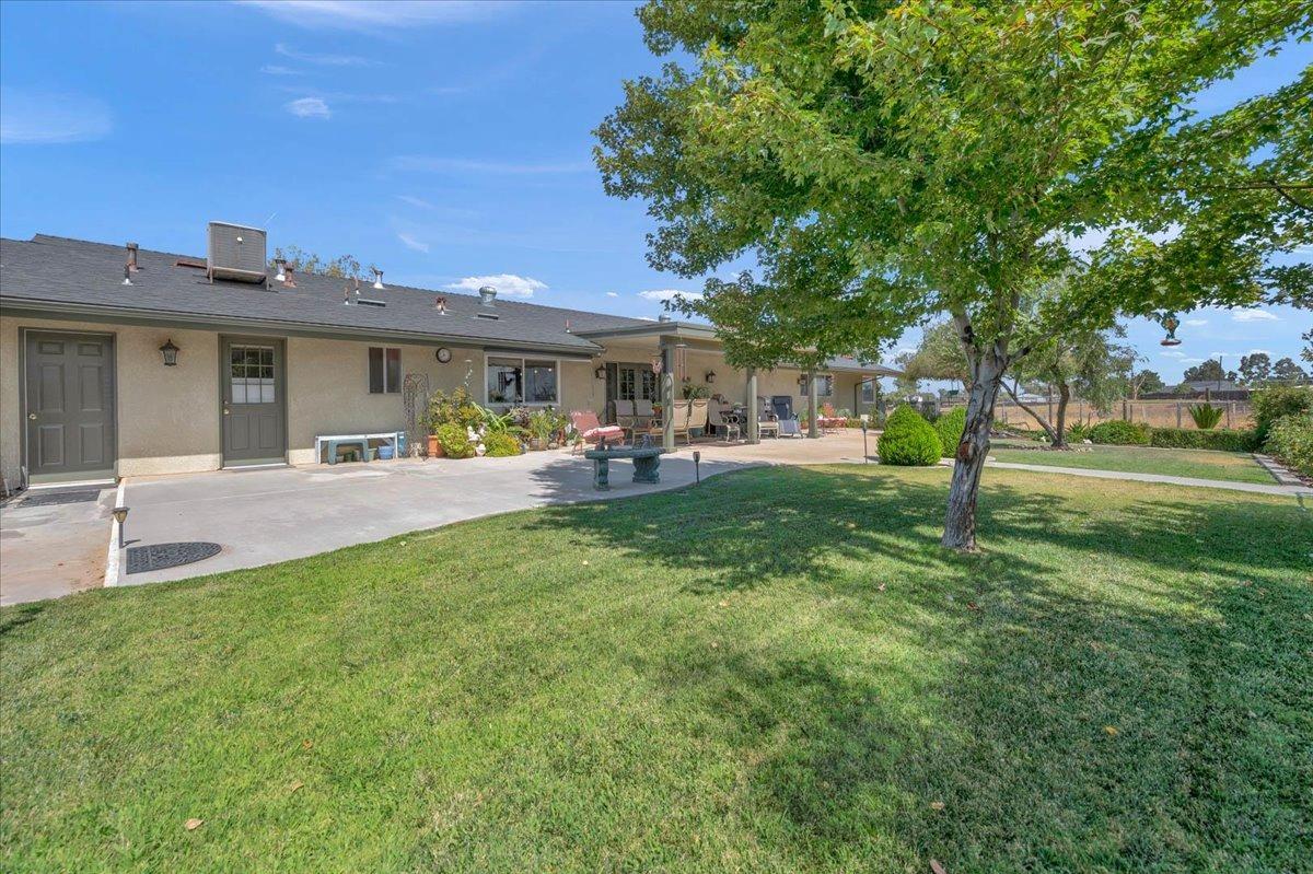 16397 Road 37 Madera, CA 93636 - Photo 32 of 74 a view of a house with a backyard porch and sitting area