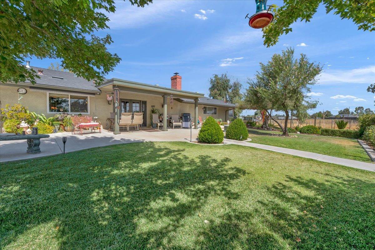 16397 Road 37 Madera, CA 93636 - Photo 33 of 74 a front view of house with yard and green space