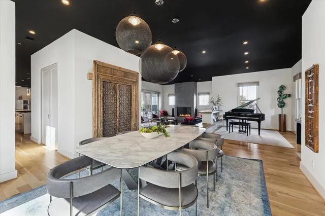 a kitchen with stainless steel appliances dining table and chairs