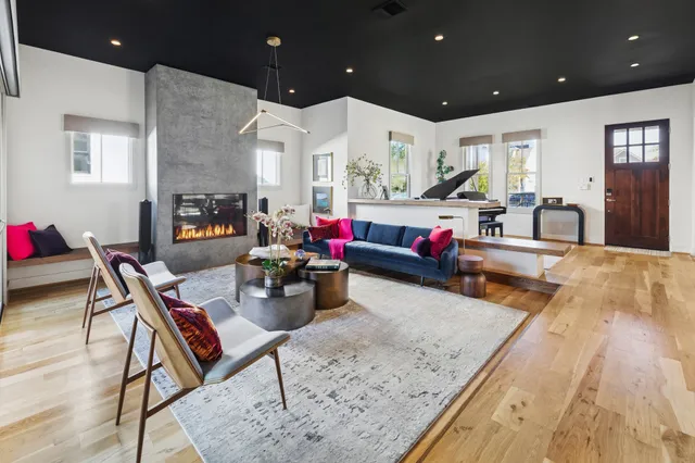 a living room filled with furniture and a wooden floor