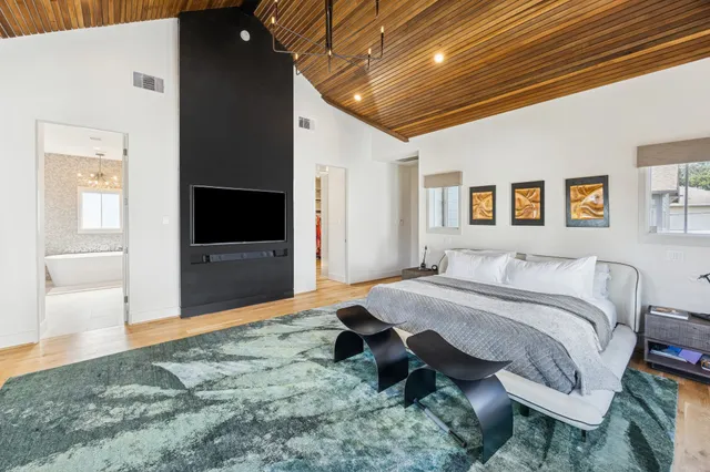 a spacious bedroom with a bed and glass door