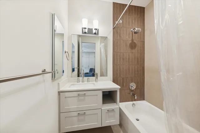 a bathroom with a sink a mirror and a bathtub