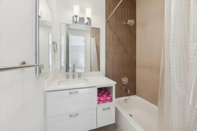 a bathroom with a sink toilet vanity and tub