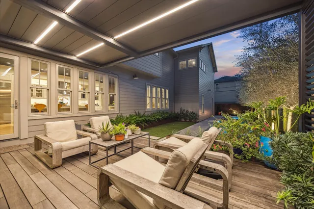 a balcony with furniture and a potted plant