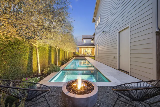 a view of a chairs and table in backyard