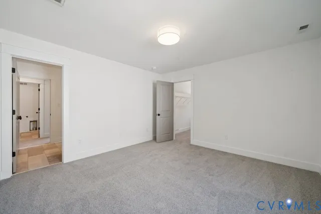 a view of an empty room and a bathroom