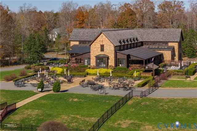 an aerial view of a house with garden swimming pool and outdoor seating
