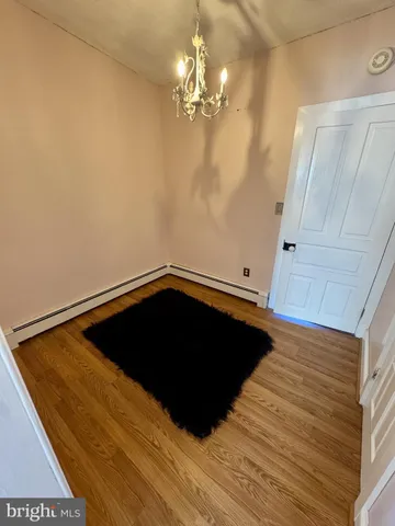 a view of a livingroom with wooden floor and staircase