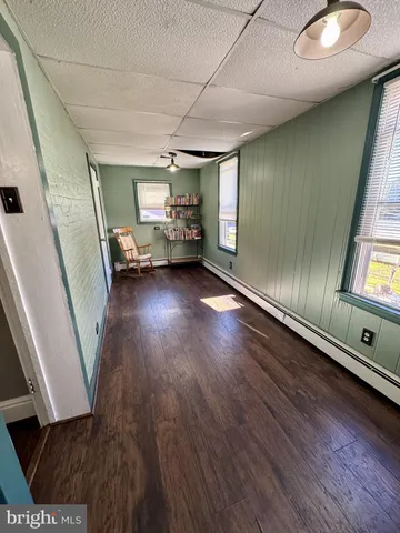 a room with pool table window and wooden floor