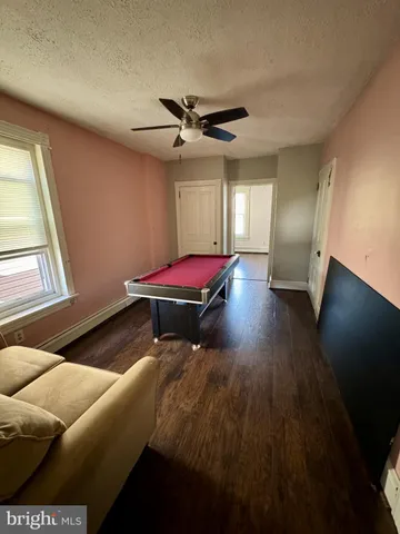 a view of room with hardwood floor and window