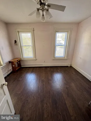 a view of a patio with table and chairs with wooden floor and fence