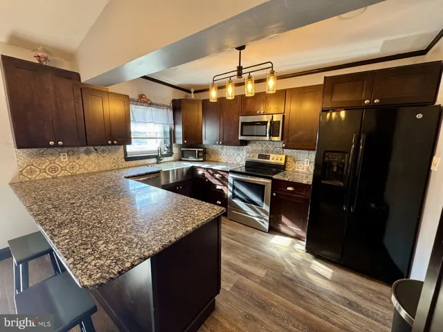 a view of a livingroom with wooden floor