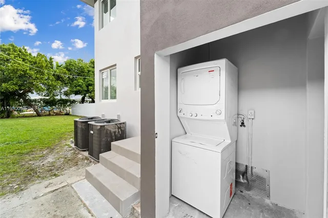 a view of a house with a yard and potted plants