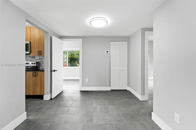 an empty room with windows and closet