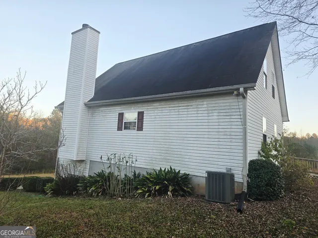 a backyard of a house with plants and outdoor seating