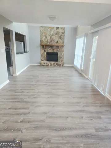 a view of empty room with window and fireplace