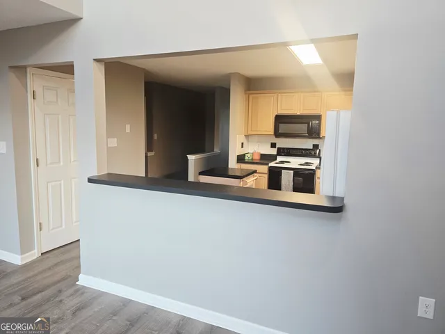 a kitchen with kitchen island a sink and a stove top oven