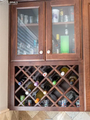 a view of a dining room with furniture a chandelier and wooden floor