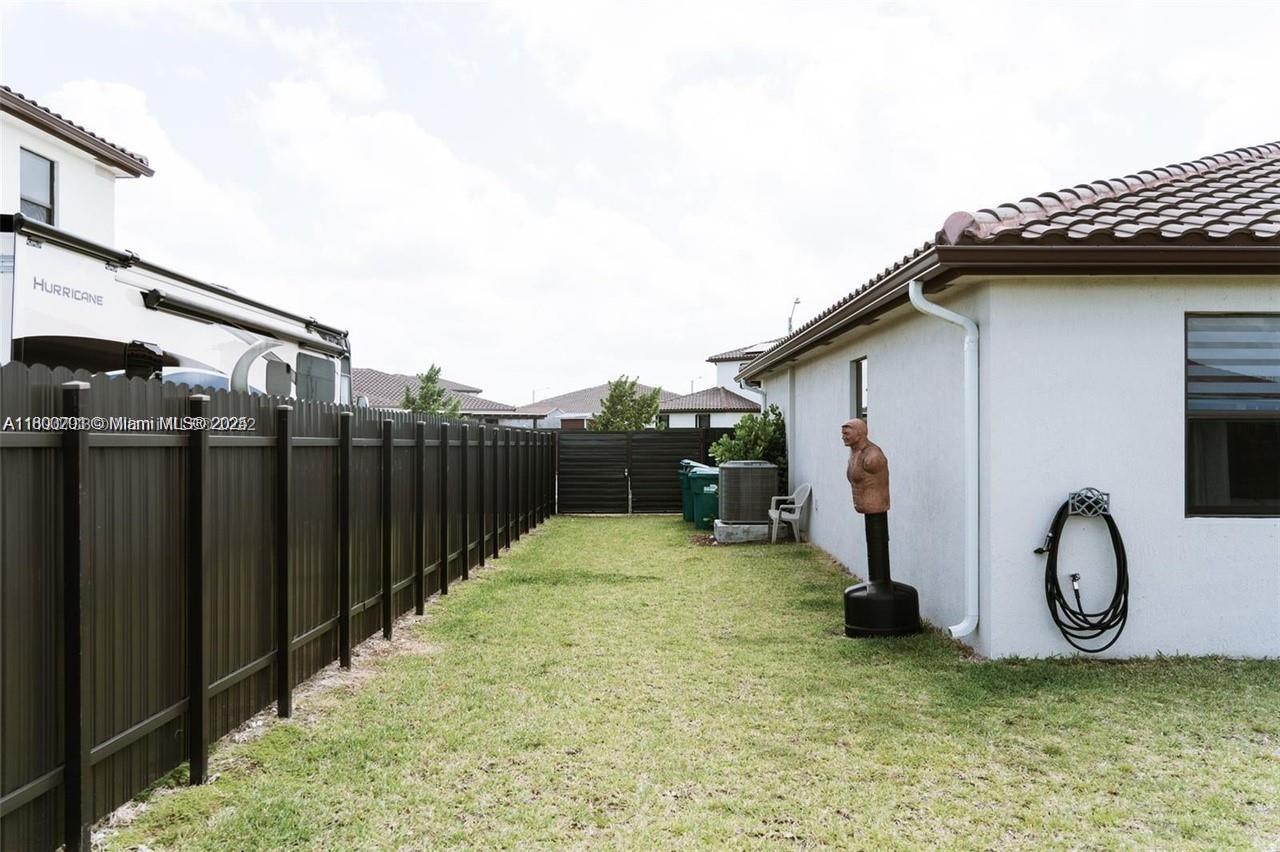 12833 Southwest 226th Street Miami, FL 33170 - Photo 13 of 13 a house view with a backyard space