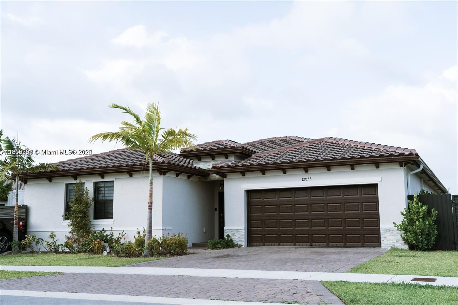 12833 Southwest 226th Street Miami, FL 33170 - Photo 3 of 13 a front view of a house with a yard