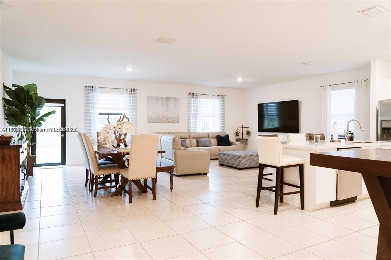 12833 Southwest 226th Street Miami, FL 33170 - Photo 5 of 13 a living room with furniture and a flat screen tv