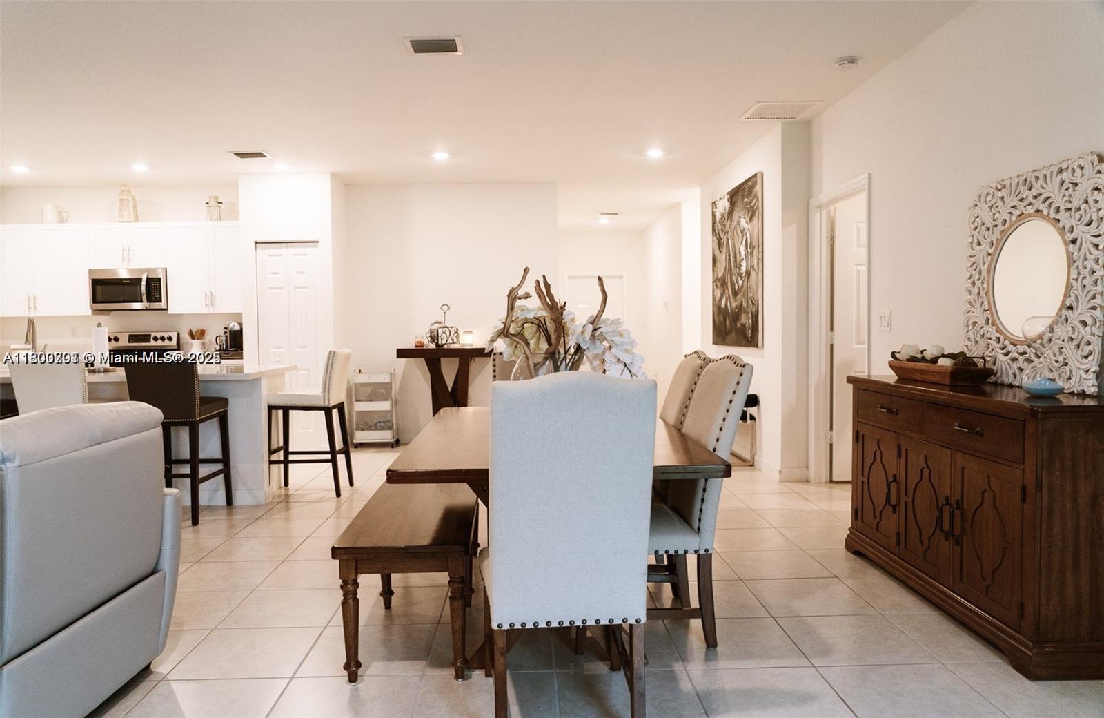 12833 Southwest 226th Street Miami, FL 33170 - Photo 9 of 13 a dining room with furniture and wooden floor