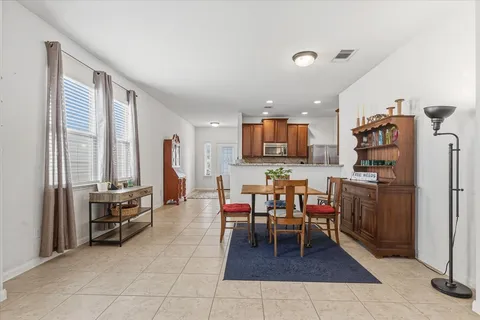 a kitchen with a table chairs and a refrigerator