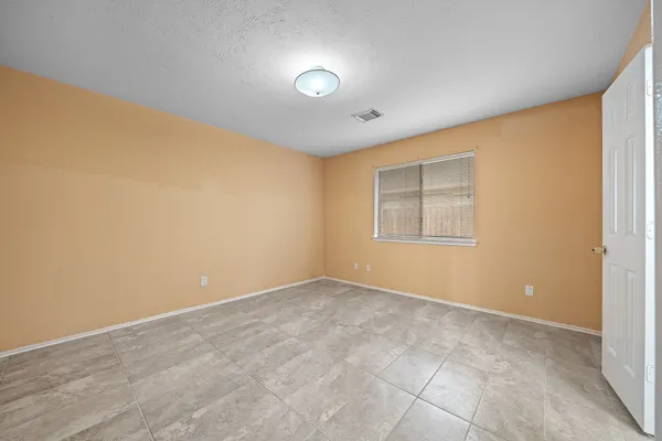an empty room with windows and closet