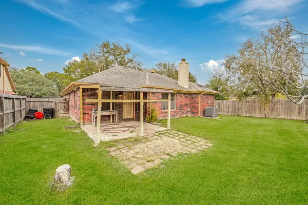 a view of a house with a yard and sitting area