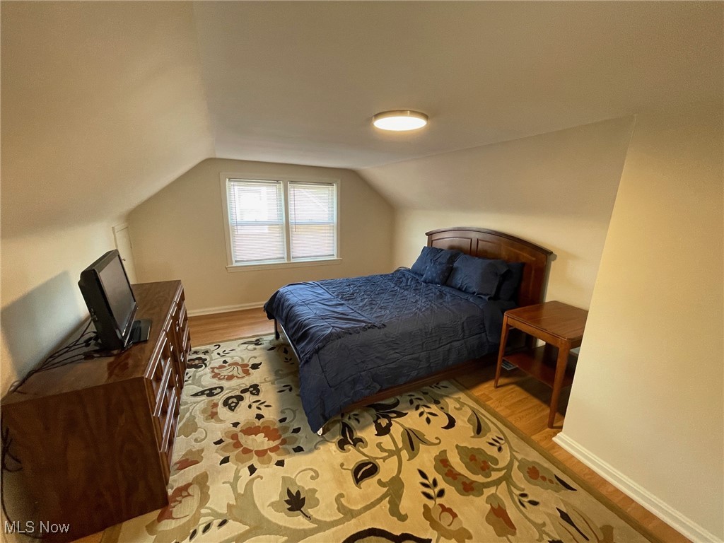 1539 Winchester Road Lyndhurst, OH 44124 - Photo 12 of 21 Bedroom featuring light hardwood / wood-style flooring and vaulted ceiling