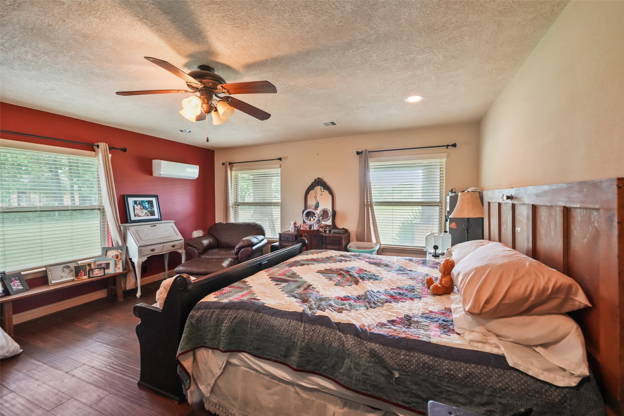 34366 Owens Road Hempstead, TX 77445 - Photo 15 of 46 Spacious primary suite with a tray ceiling, ceiling fan, abundant natural light, and ample room for a sitting area or additional furnishings.