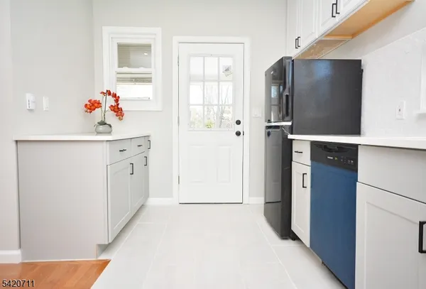 a kitchen with stainless steel appliances granite countertop a sink a stove a dining table and chairs