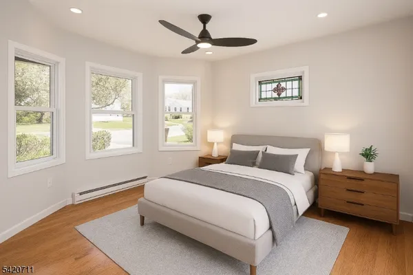 a view of empty room with wooden floor and window