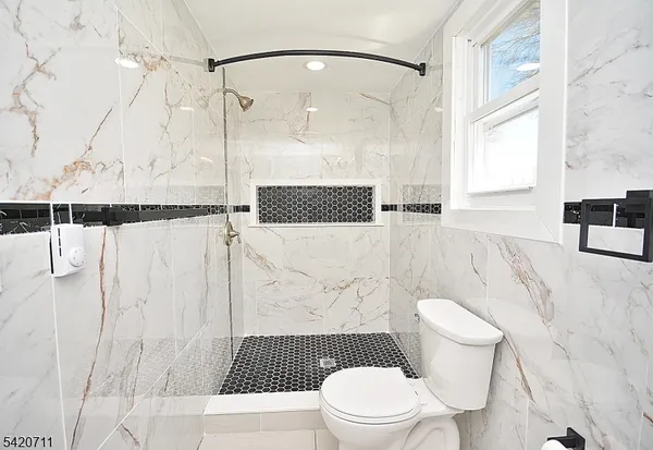 a white toilet sitting next to a bathroom sink