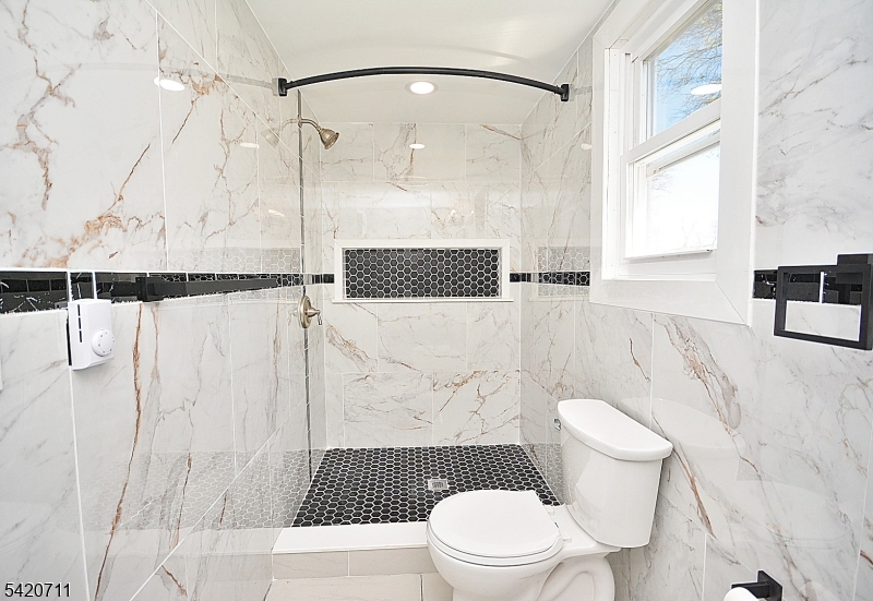 1324 George Street Plainfield, NJ 07062 - Photo 3 of 24 a white toilet sitting next to a bathroom sink
