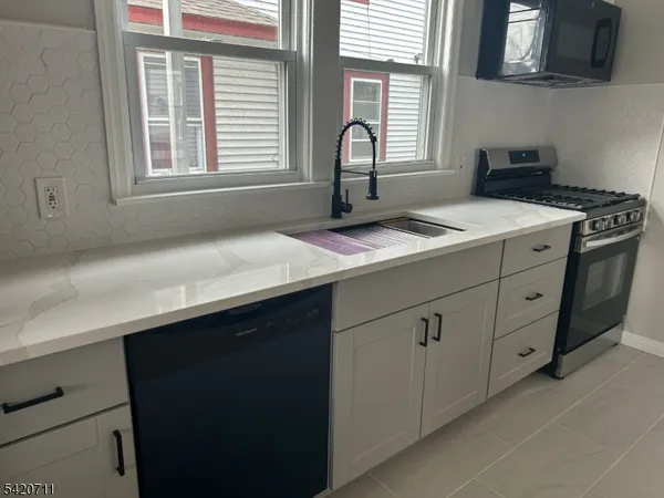 a kitchen with a sink and cabinets