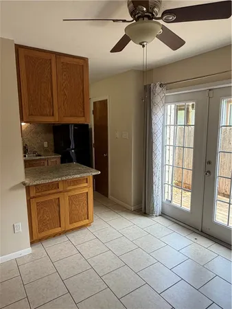 a kitchen with stainless steel appliances granite countertop a sink and a refrigerator