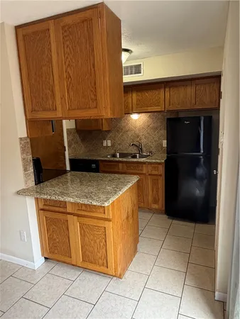 a kitchen with a stove and a refrigerator