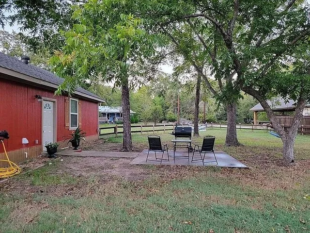 a view of a house with backyard space and sitting area