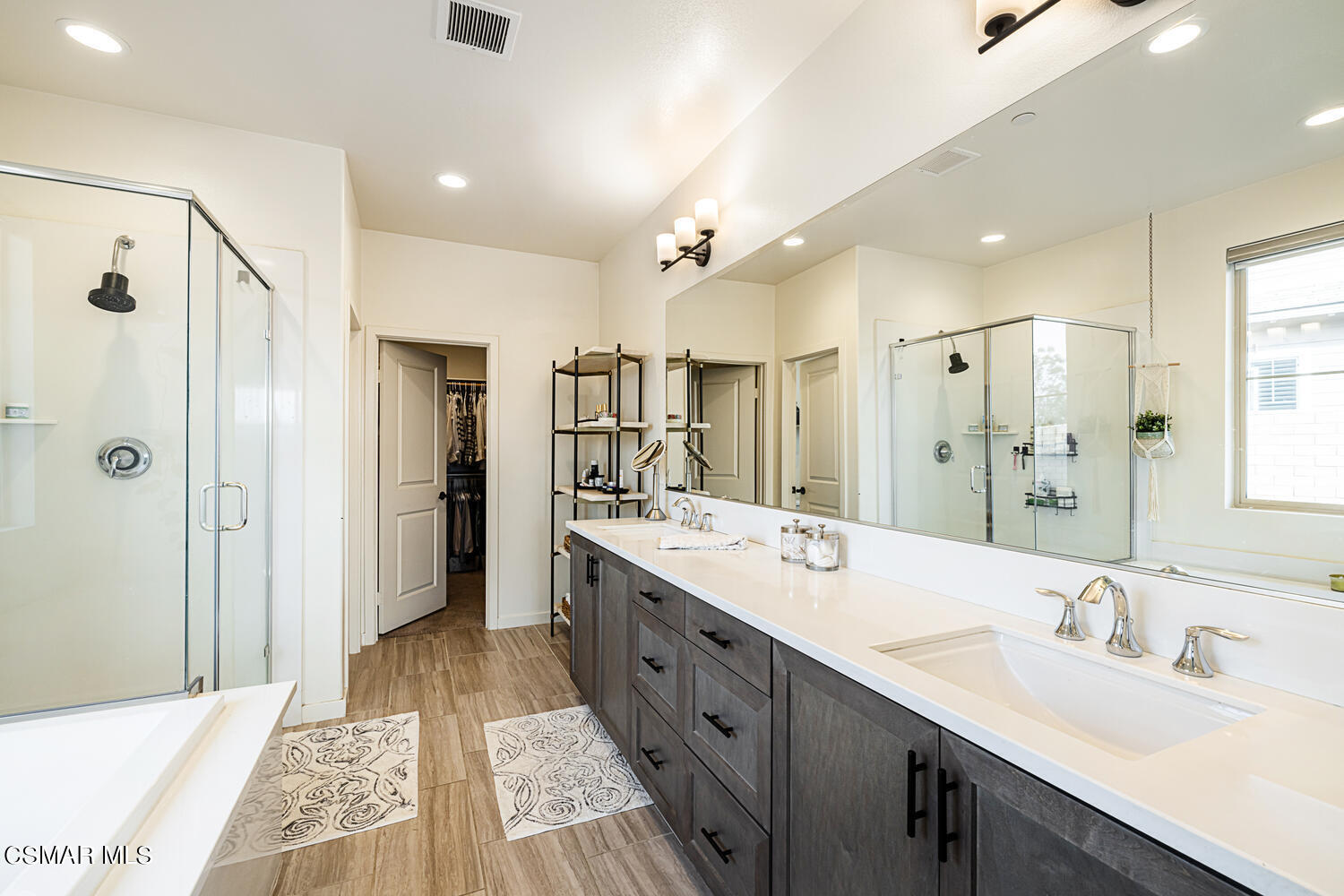 4616 Fannin Drive Simi Valley, CA 93063 - Photo 15 of 29 a large bathroom with a double vanity sink a large mirror and shower