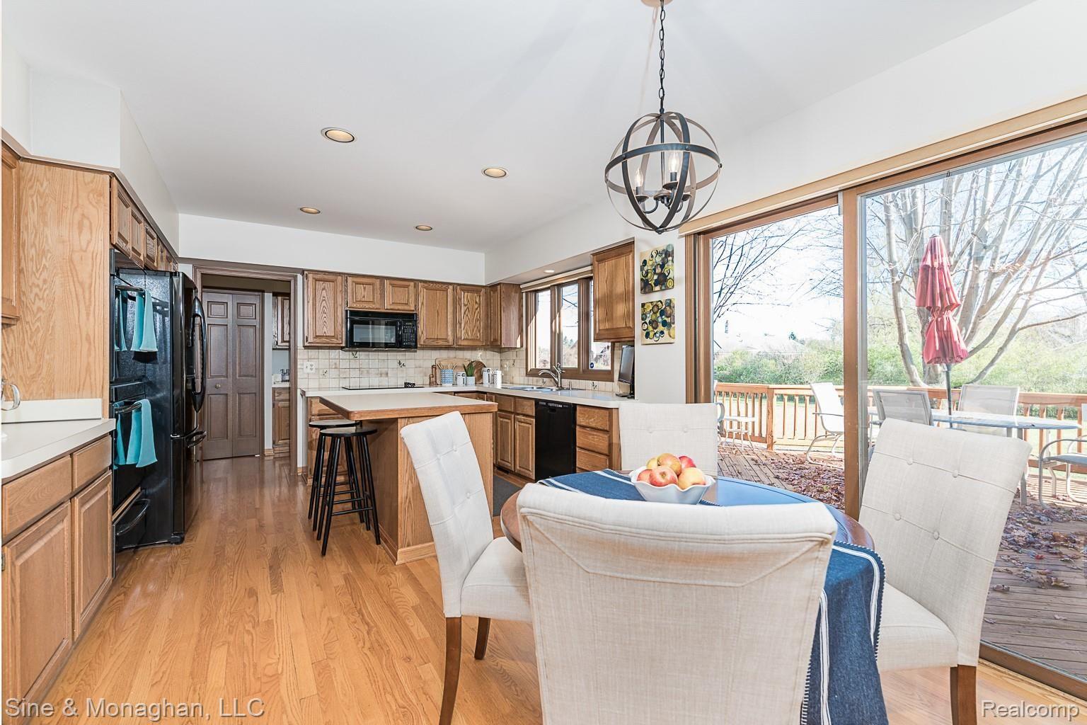 4906 Rivers Edge Drive Troy, MI 48098 - Photo 23 of 60 Kitchen nook with new chandelier, door all to deck