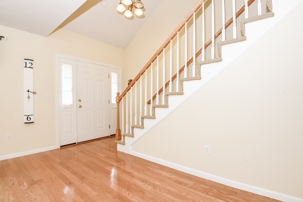 615 Nashua Road, Unit 9 Dracut, MA 01826 - Photo 14 of 30 a view of staircase with wooden floor and white walls