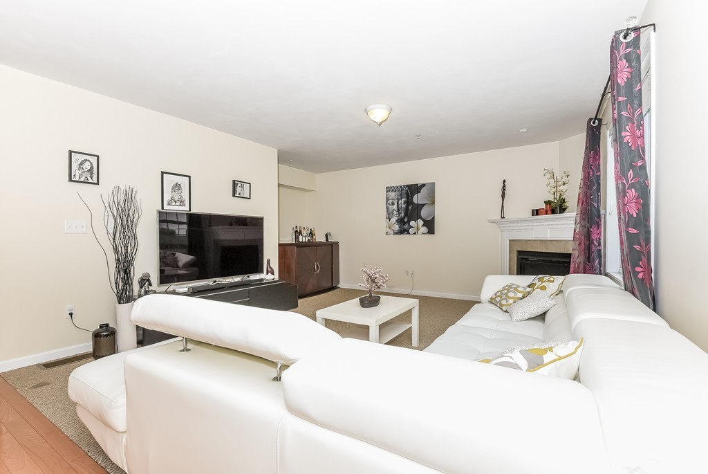 615 Nashua Road, Unit 9 Dracut, MA 01826 - Photo 15 of 30 a living room with furniture a flat screen tv and a fireplace