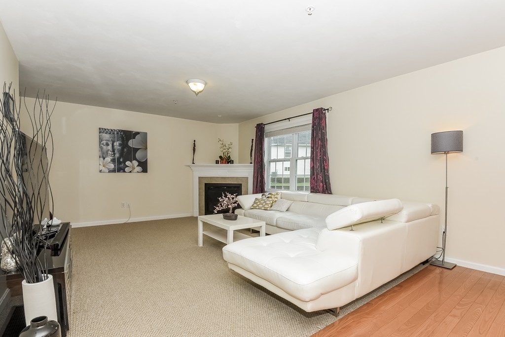 615 Nashua Road, Unit 9 Dracut, MA 01826 - Photo 16 of 30 a living room with furniture and a fireplace