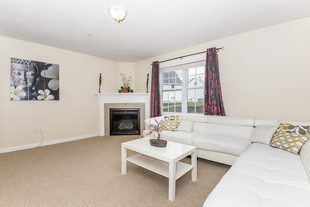 615 Nashua Road, Unit 9 Dracut, MA 01826 - Photo 17 of 30 a living room with furniture and a fireplace