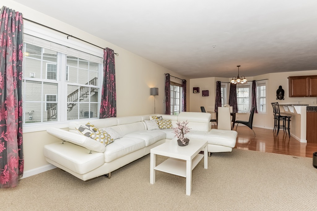 615 Nashua Road, Unit 9 Dracut, MA 01826 - Photo 18 of 30 a living room with furniture and a large window