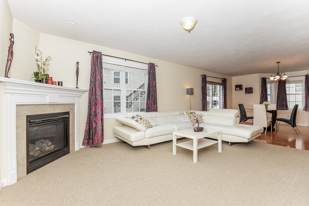 615 Nashua Road, Unit 9 Dracut, MA 01826 - Photo 19 of 30 a living room with furniture and a fireplace